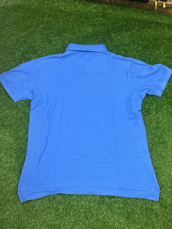 light blue Nautica short-sleeve polo with the sailboat logo on the chest. Medium