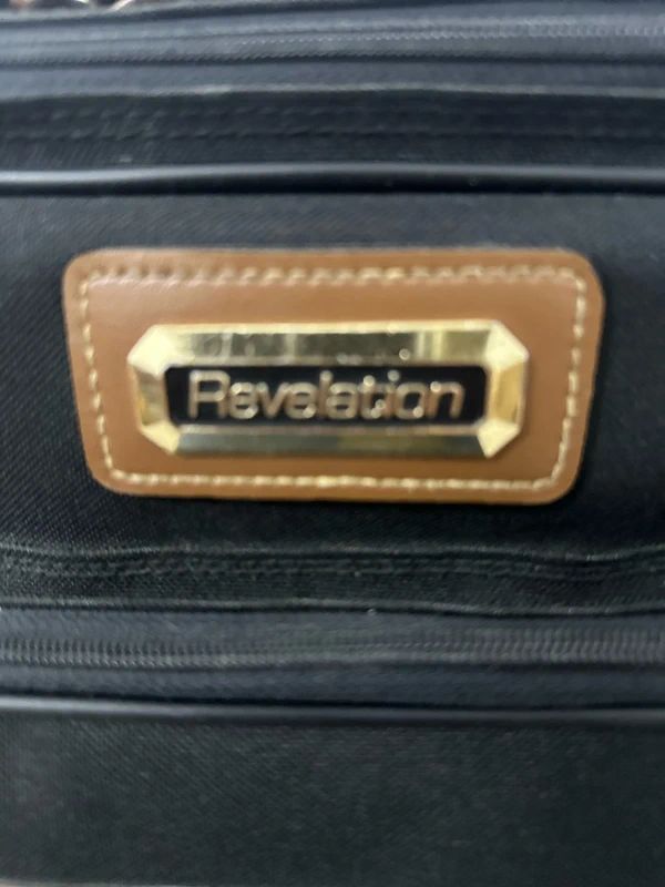 Revelation black and brown travel holdall bag with a detachable shoulder strap