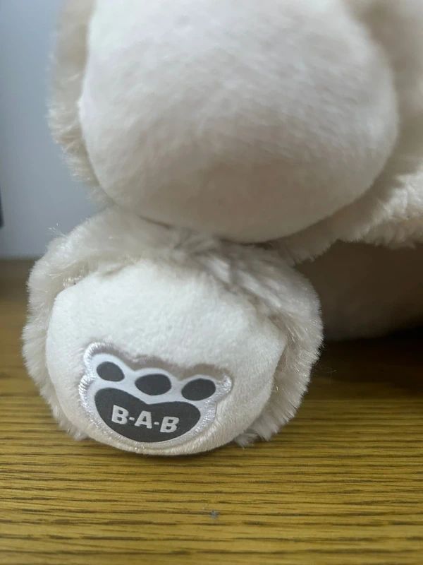 Build-A-Bear Workshop husky plush features a signature paw print logo.
