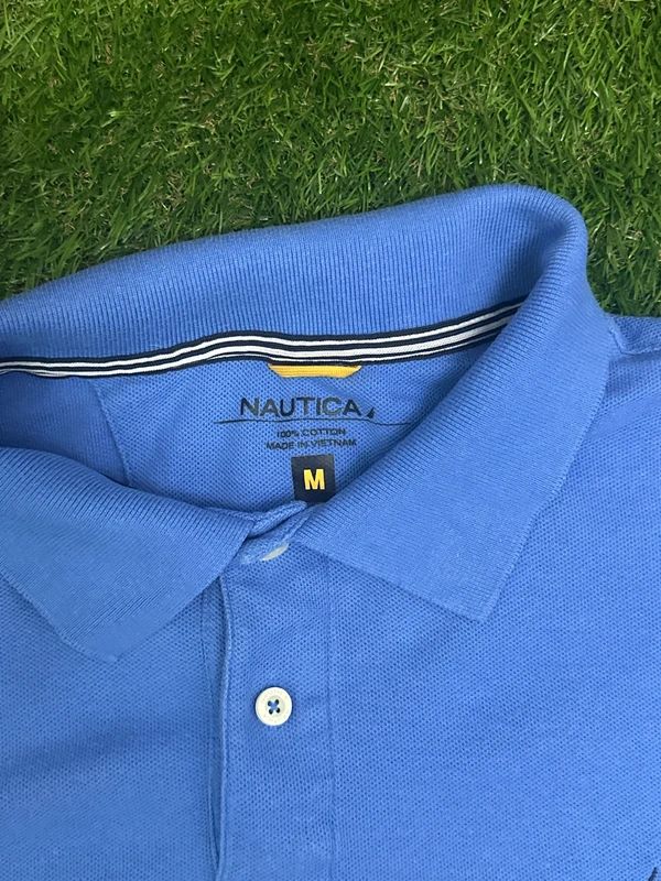 light blue Nautica short-sleeve polo with the sailboat logo on the chest. Medium