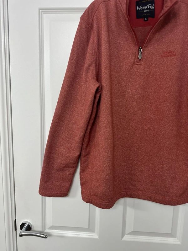 red Weird Fish quarter-zip jumper with a distinctive fish-shaped zipper pull.