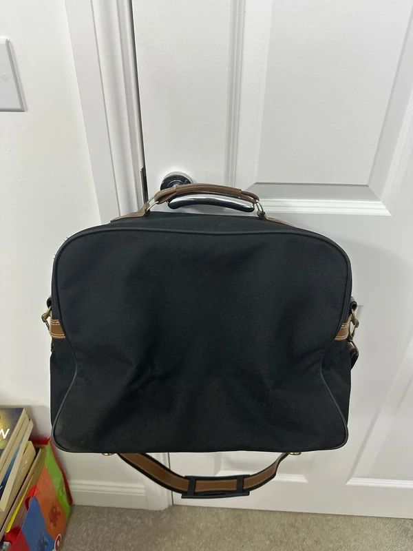 Revelation black and brown travel holdall bag with a detachable shoulder strap