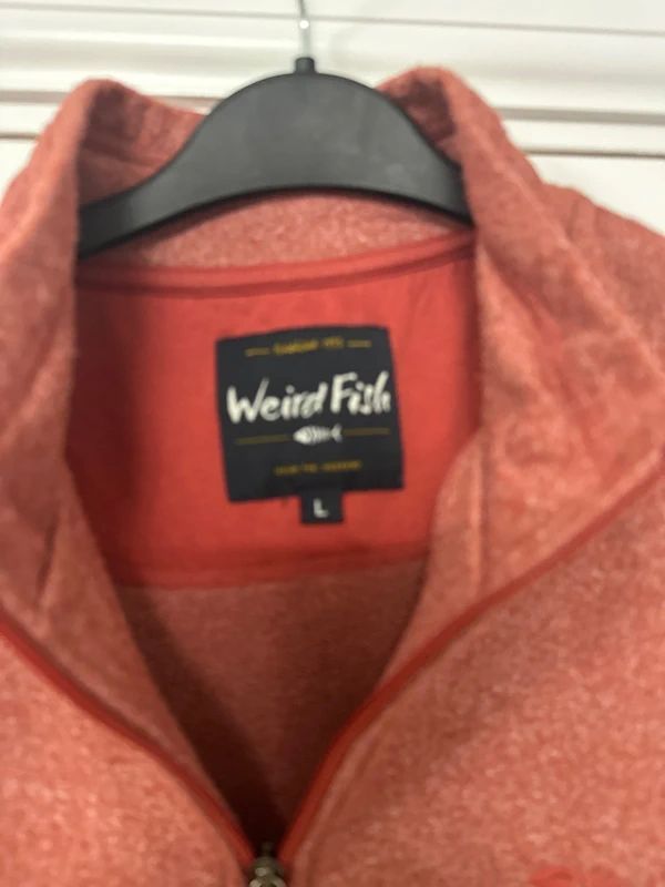 red Weird Fish quarter-zip jumper with a distinctive fish-shaped zipper pull.