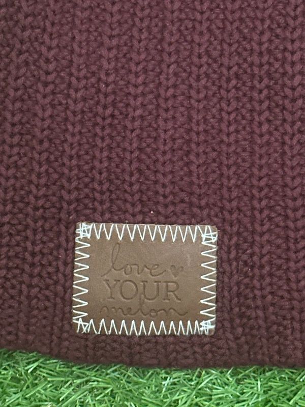 burgundy Love Your Melon beanie features a signature stitched leather logo patch