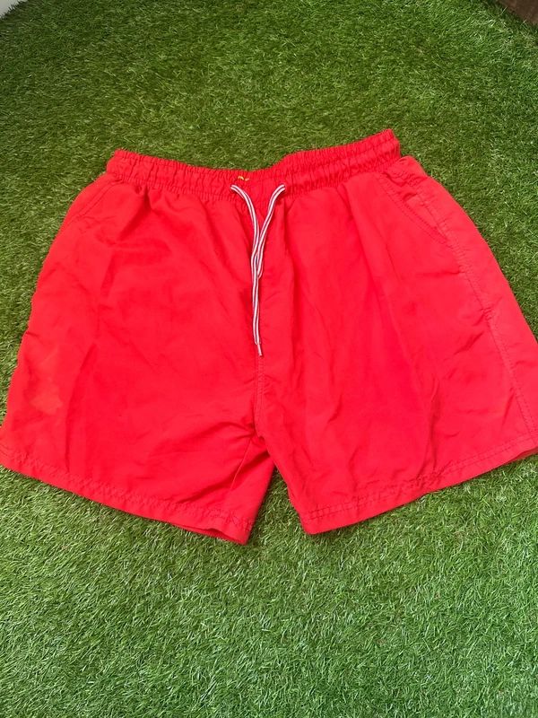 Men’s red swim shorts in size large