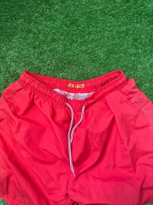 Men’s red swim shorts in size large