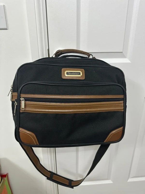 Revelation black and brown travel holdall bag with a detachable shoulder strap