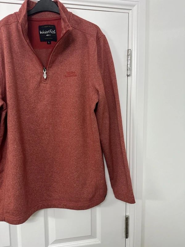 red Weird Fish quarter-zip jumper with a distinctive fish-shaped zipper pull.
