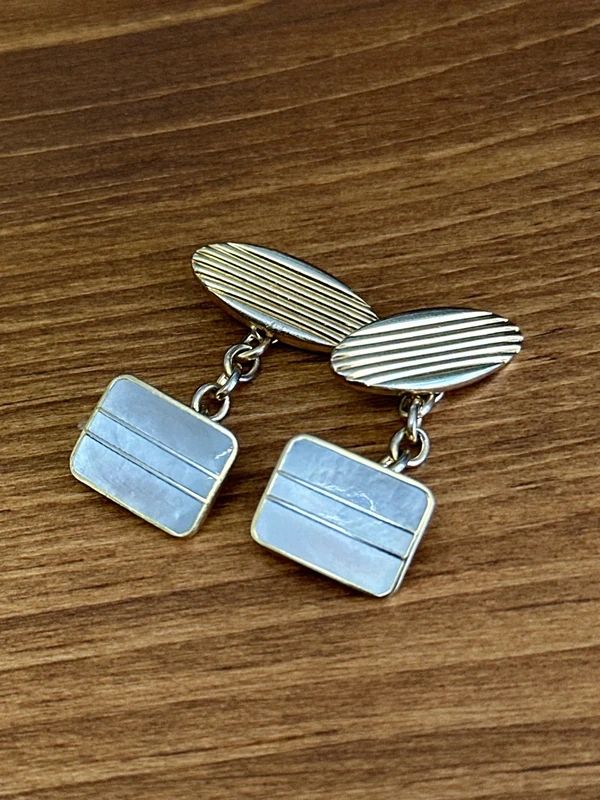 vintage 1970s cufflinks feature a distinct striped design on the face